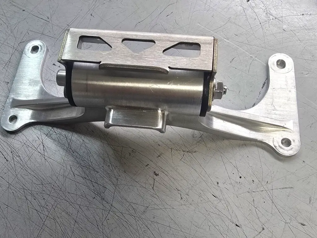 Machined metal bracket assembly on a workbench