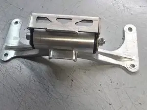 Machined metal bracket assembly on a workbench