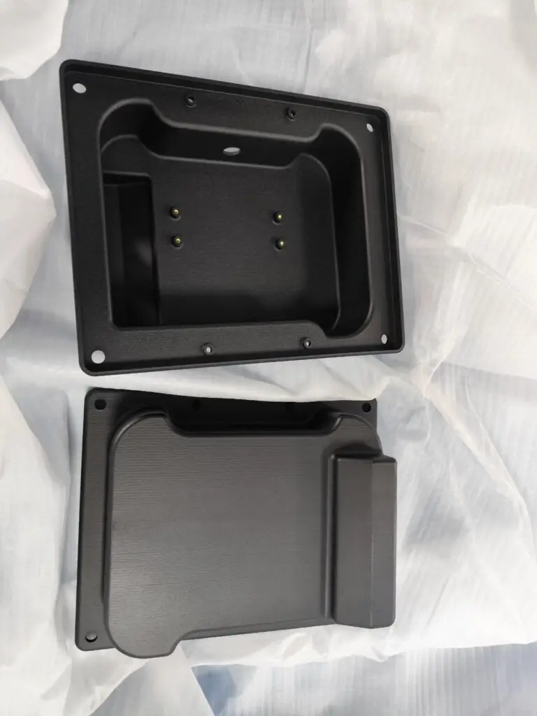 Two black 3D-printed nylon enclosure halves